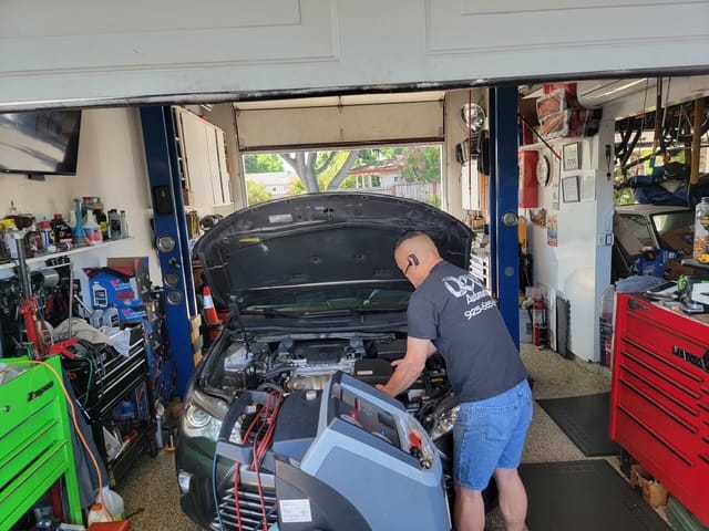 Auto repair technician diagnosing vehicle engine in Pacheco CA