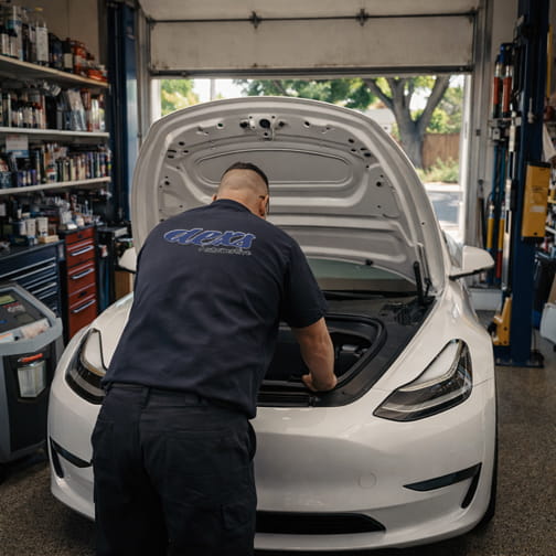 Tesla vehicle in an auto repair bay at Dex’s Automotive